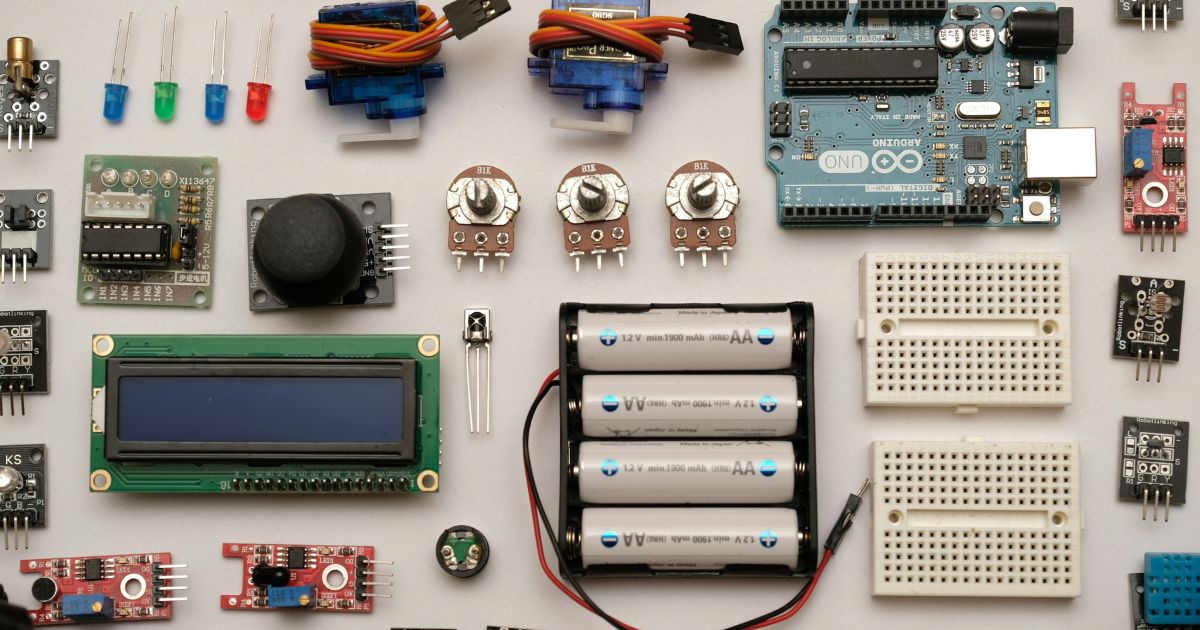 An Arduino Uno board laid out with servos, sensors, breadboards, potentiometers and an LCD module